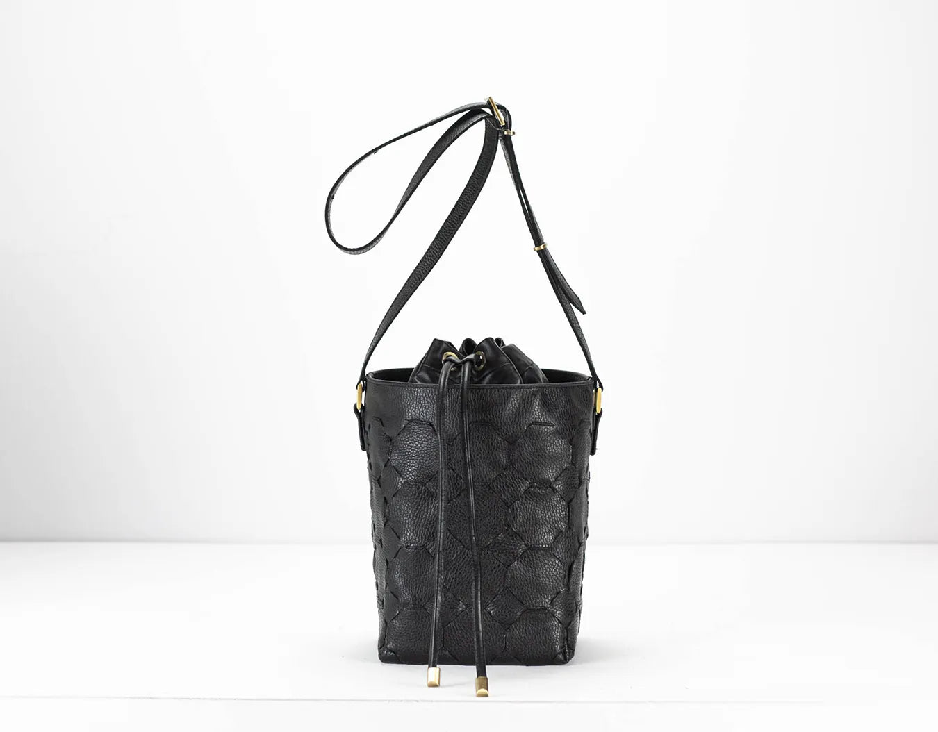 Black textured bucket bag with a drawstring on a white background