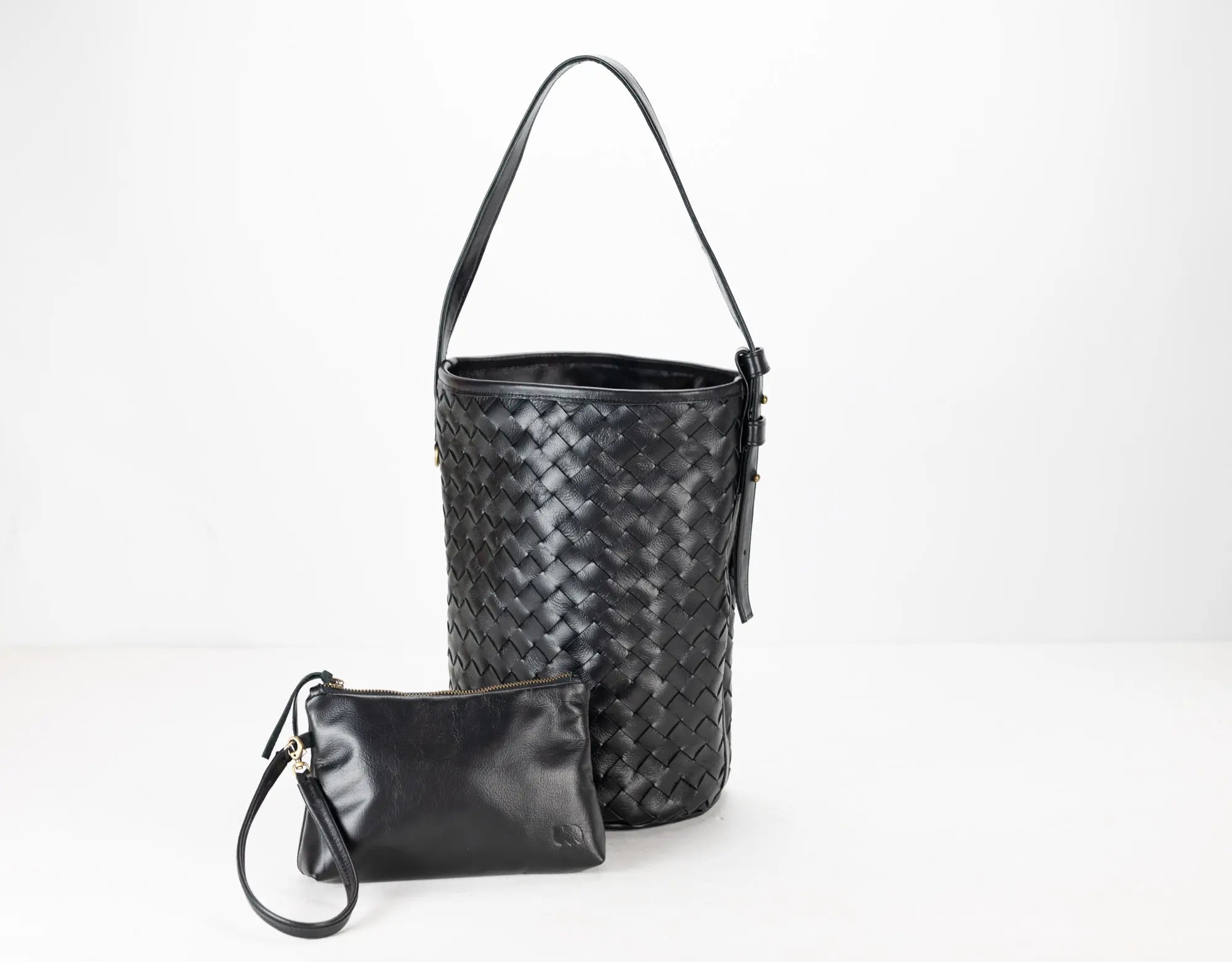 Black woven handbag and matching pouch on a white background