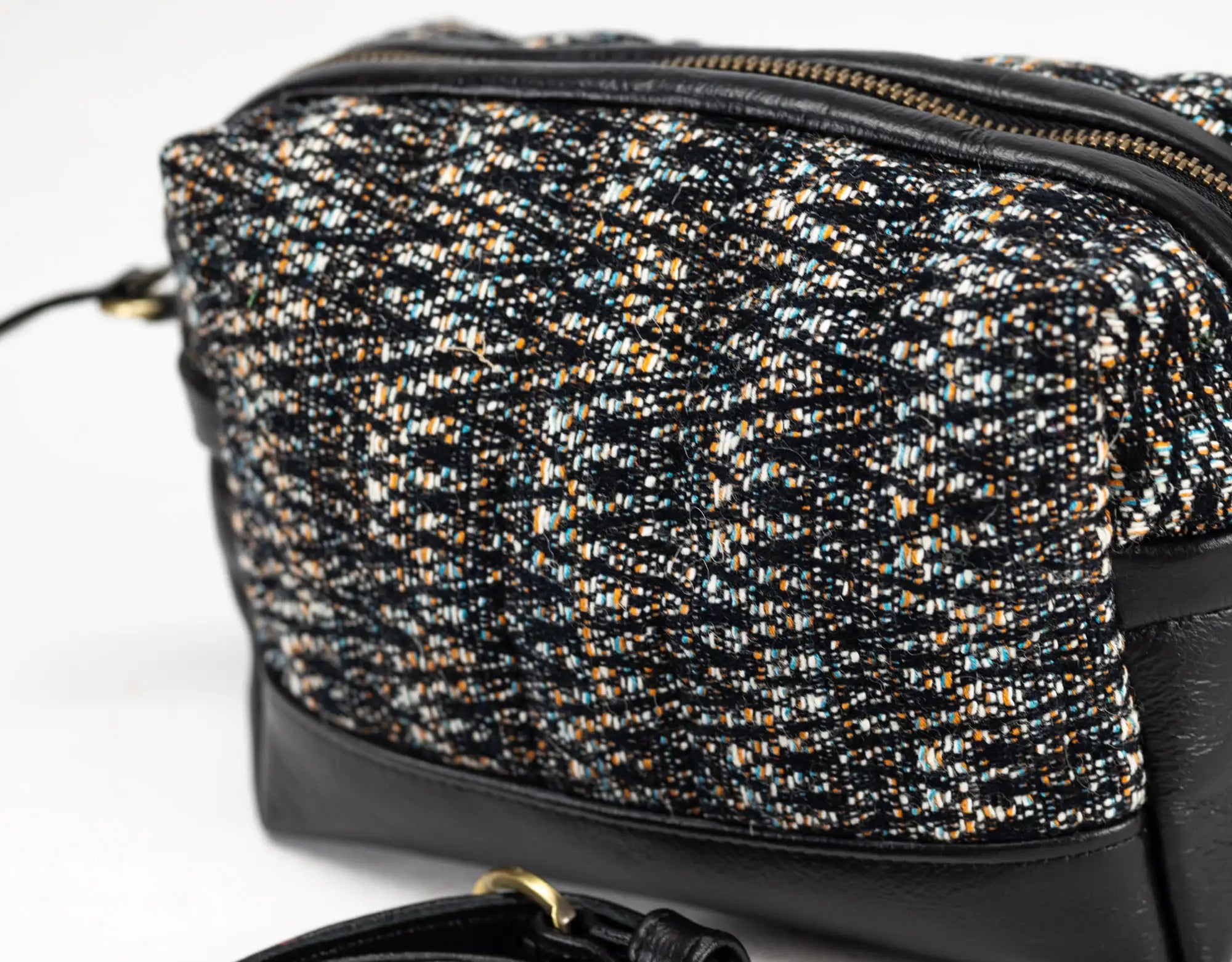 Black and gold patterned handbag on a white background