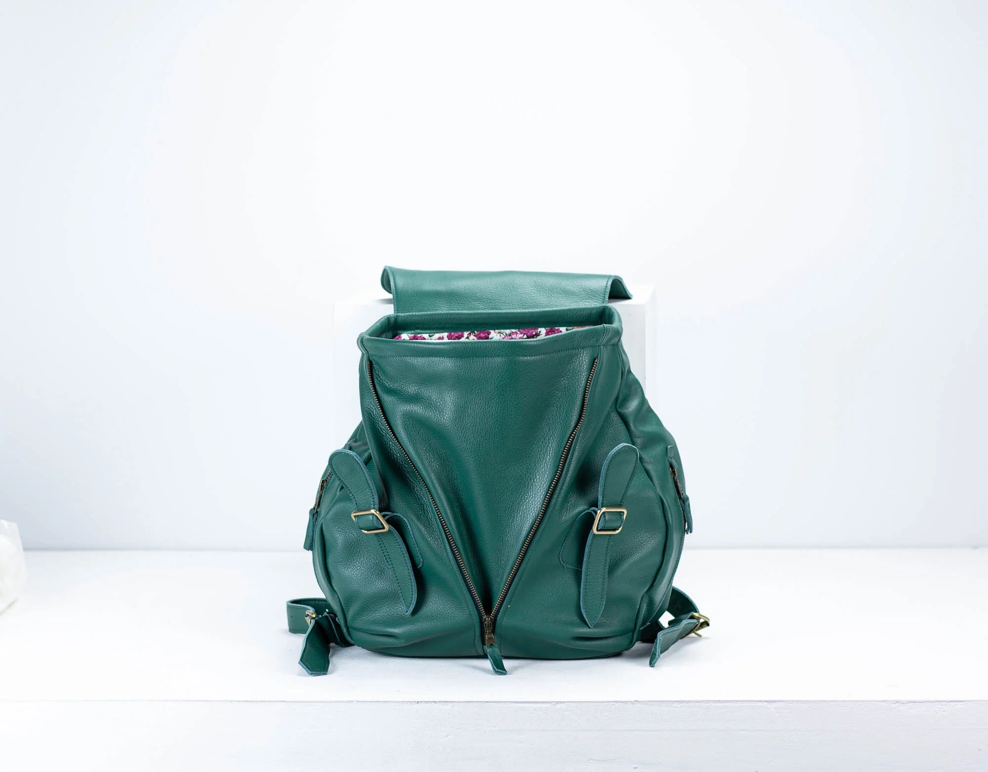 Green backpack on a white background