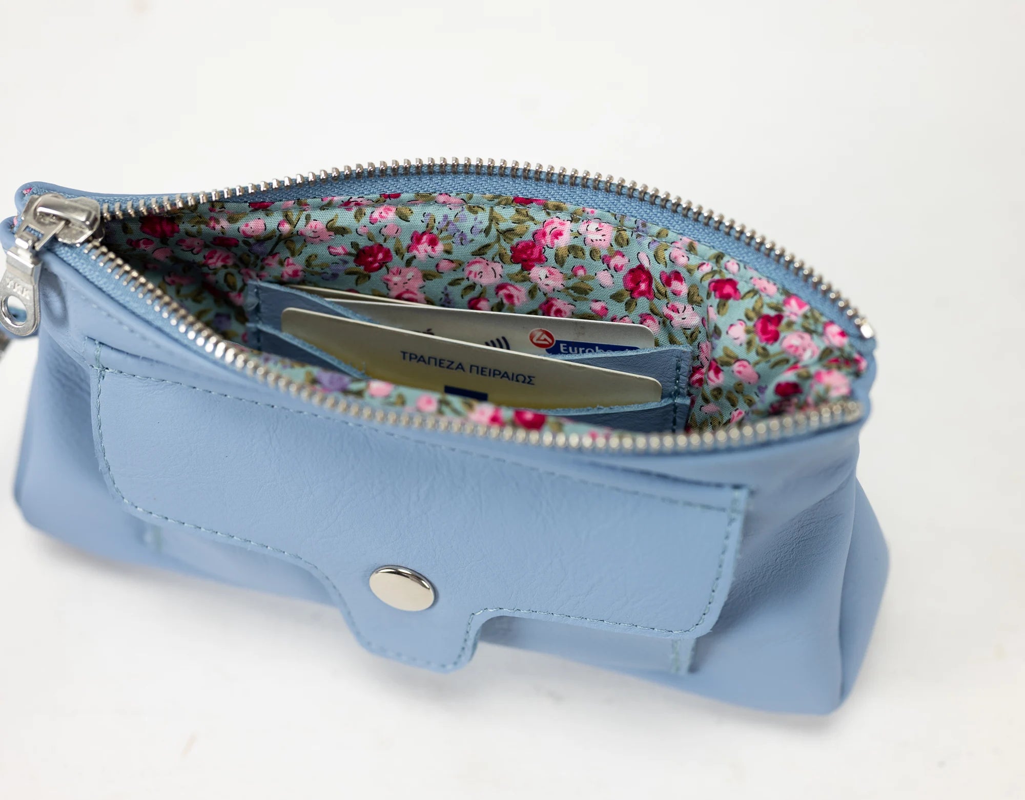 Blue pouch with floral interior on a white background