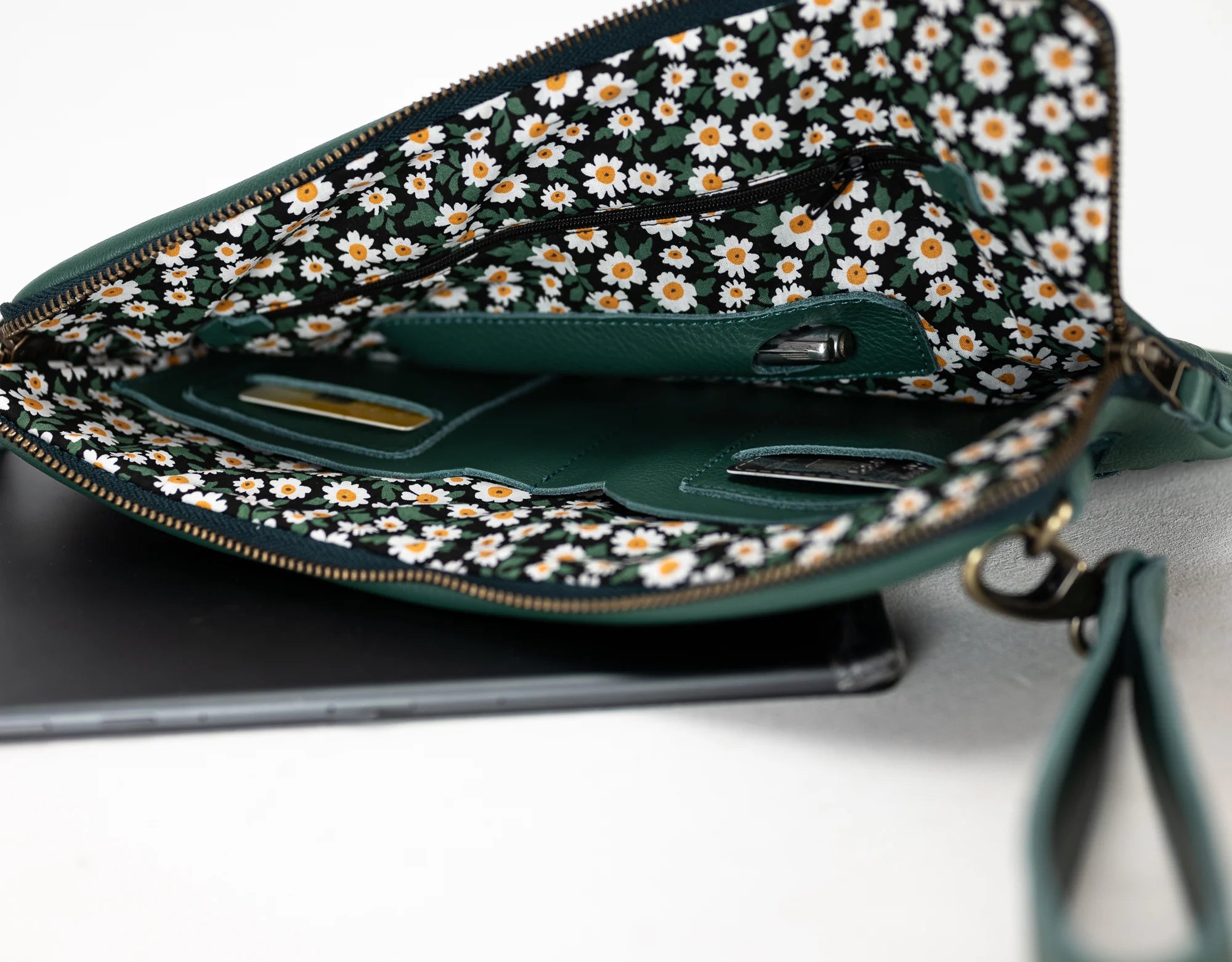 Green handbag with floral pattern on a white background