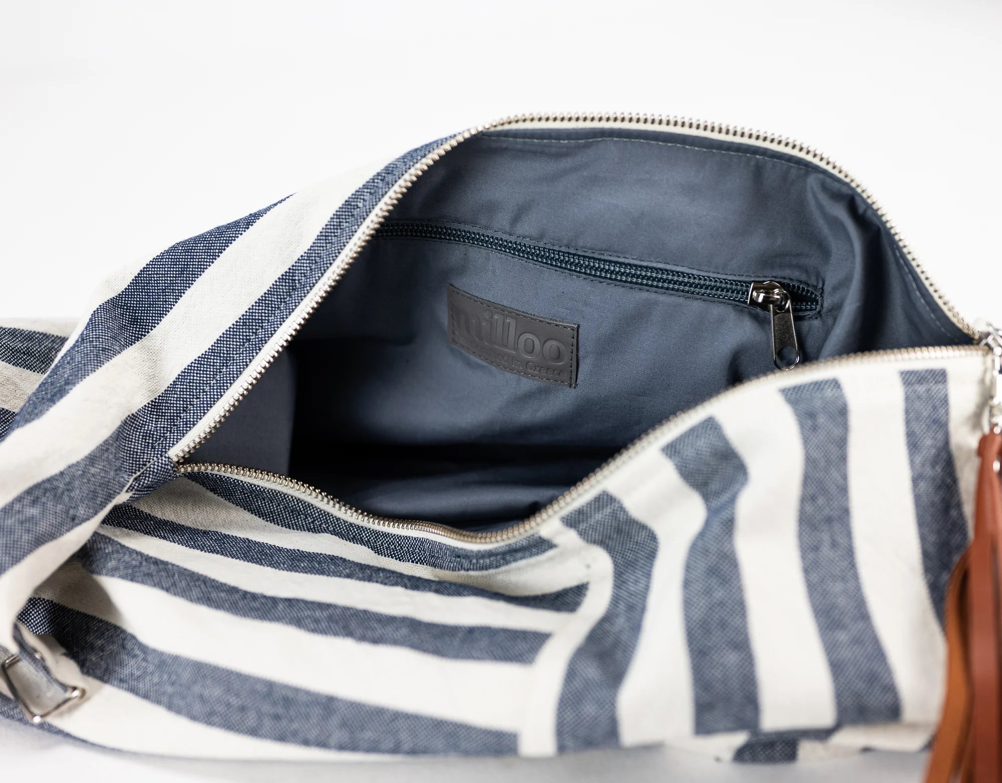 Open striped bag with visible brand logo on a light gray background