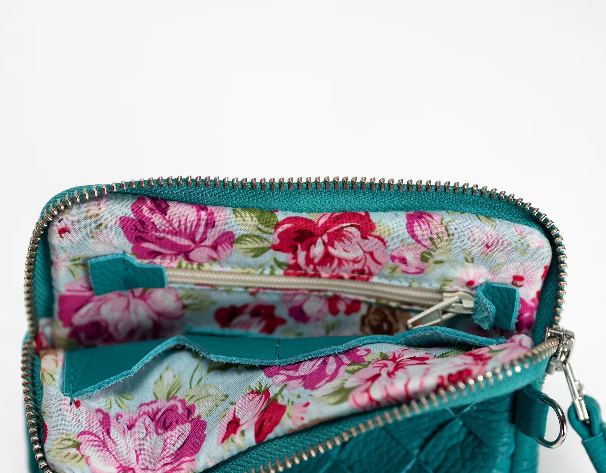 Floral-patterned wallet with a turquoise border on a white background