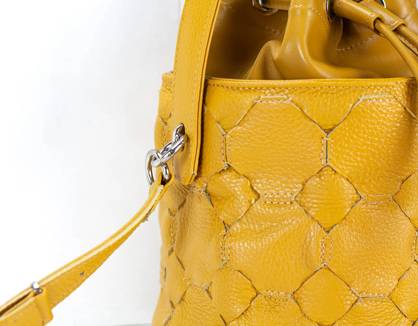 Yellow textured handbag on a white backgroundy