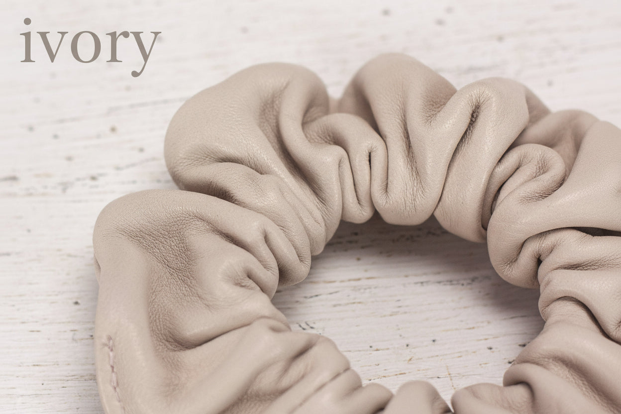 Beige scrunchie on a light wooden surface