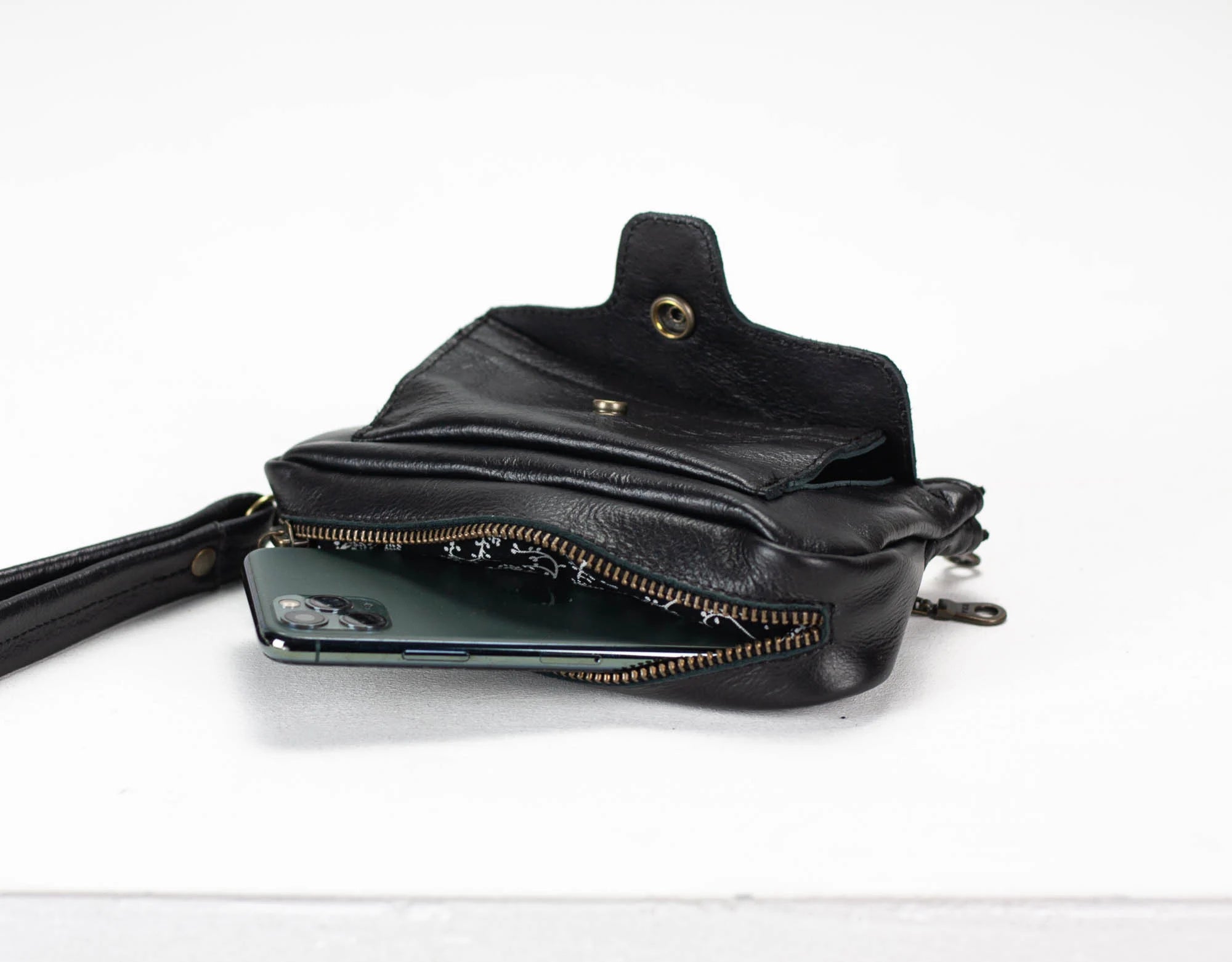 Black leather pouch with a zipper on a white background