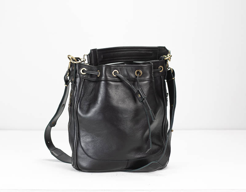 Black leather bucket bag with gold hardware on a white background