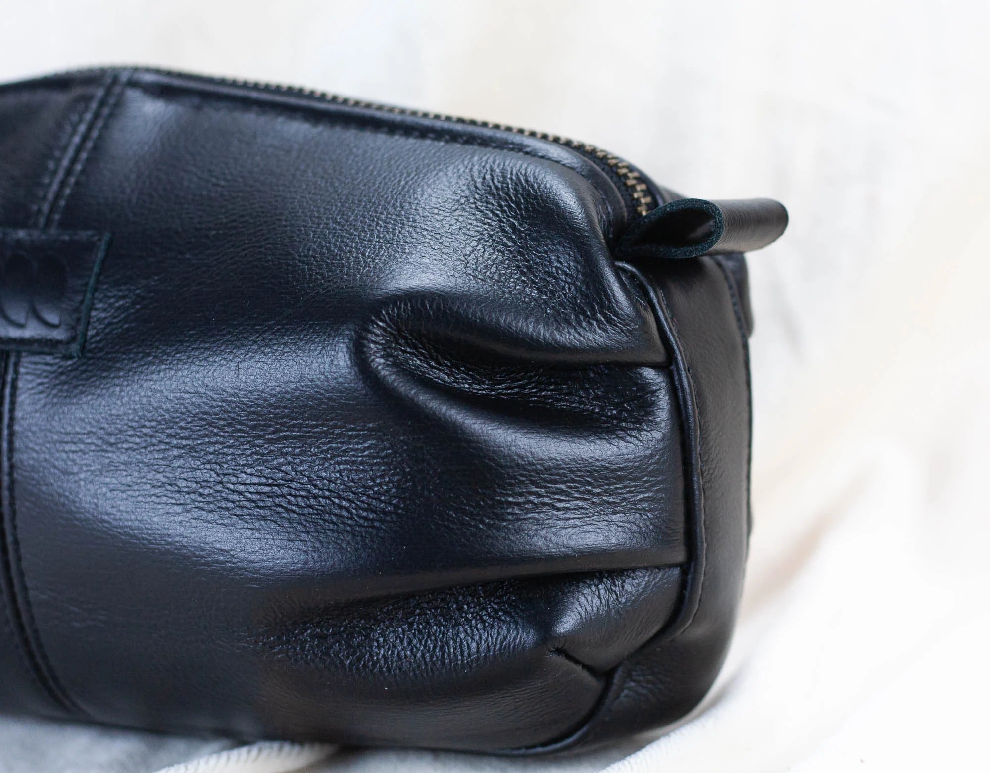 Black leather handbag on a light background