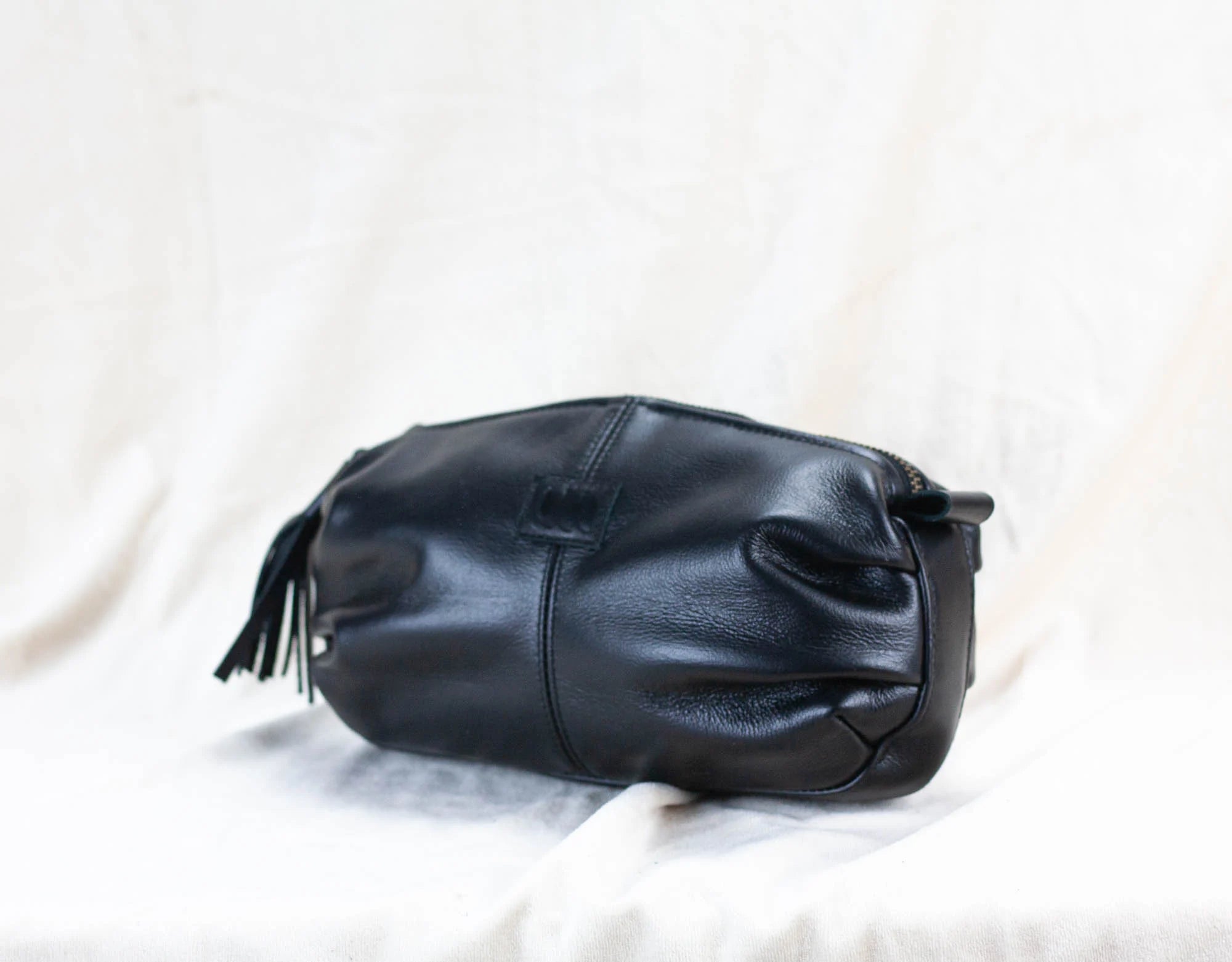 Black leather handbag on a white background