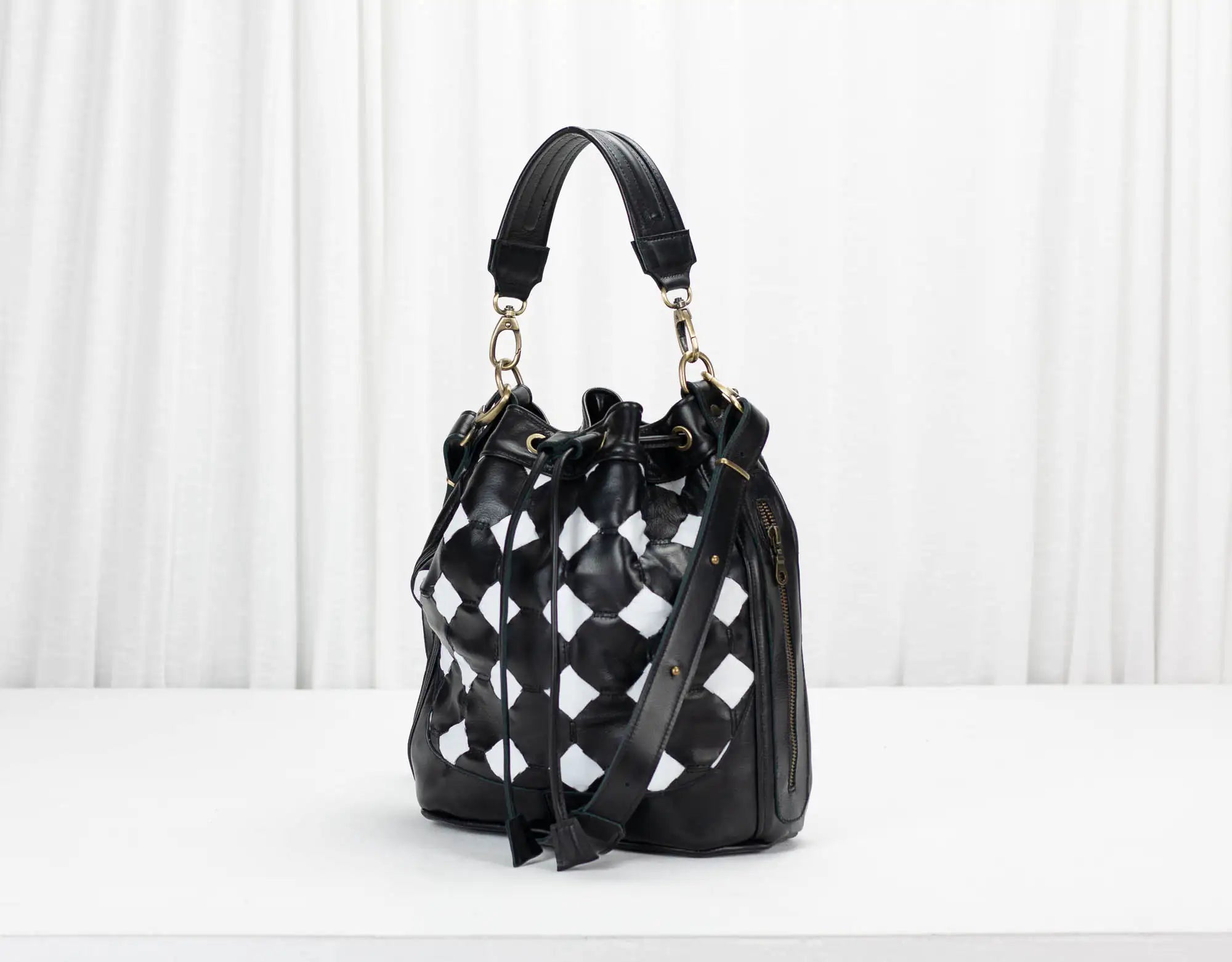 Black and white checkered handbag on a white background
