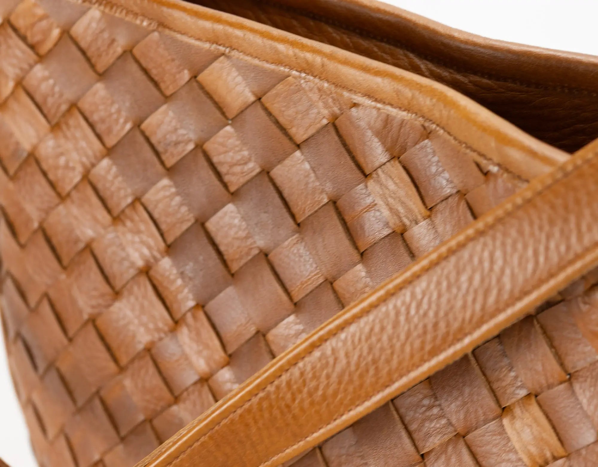 Close-up of a woven brown leather handbag