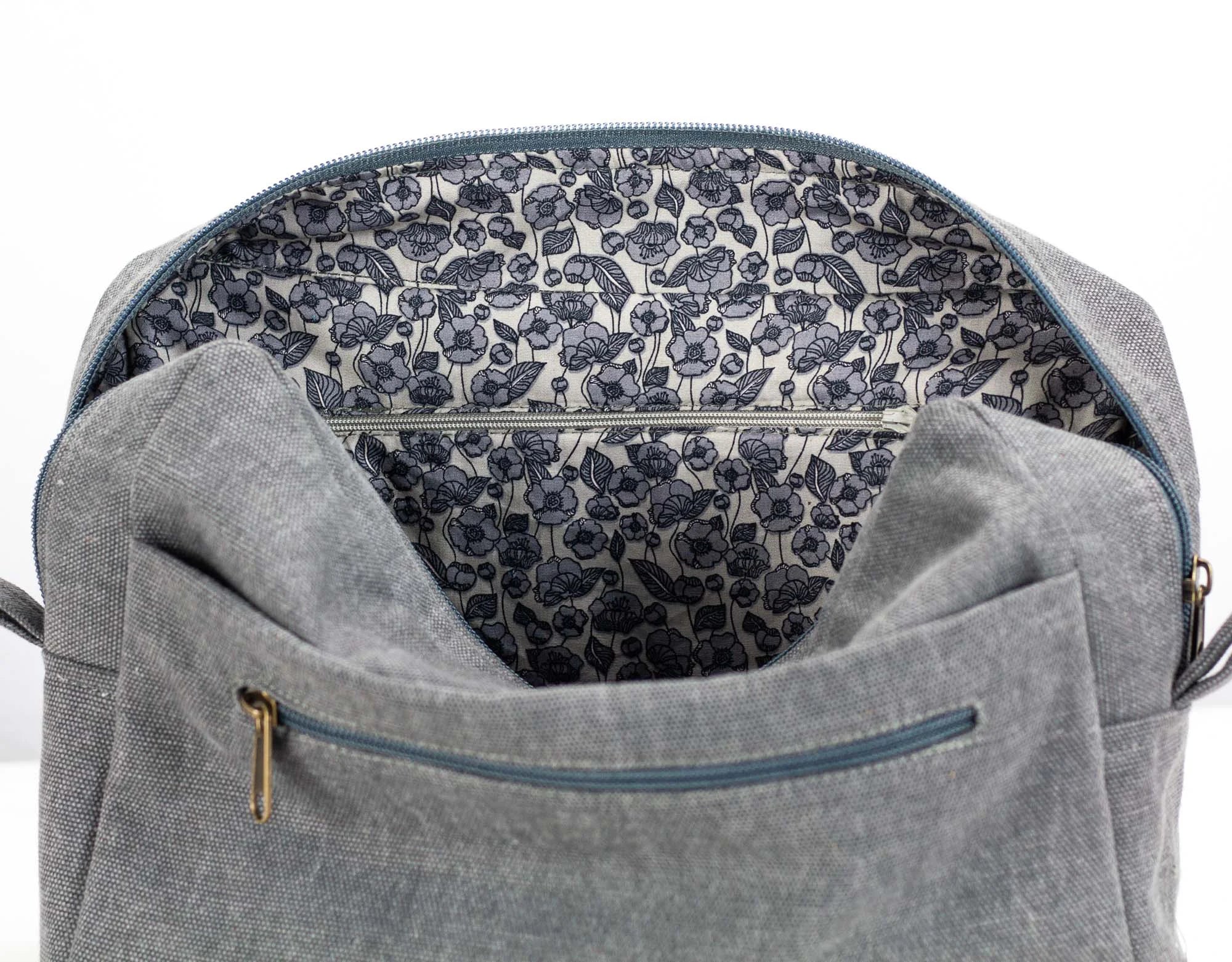 Gray backpack with floral lining on a white background