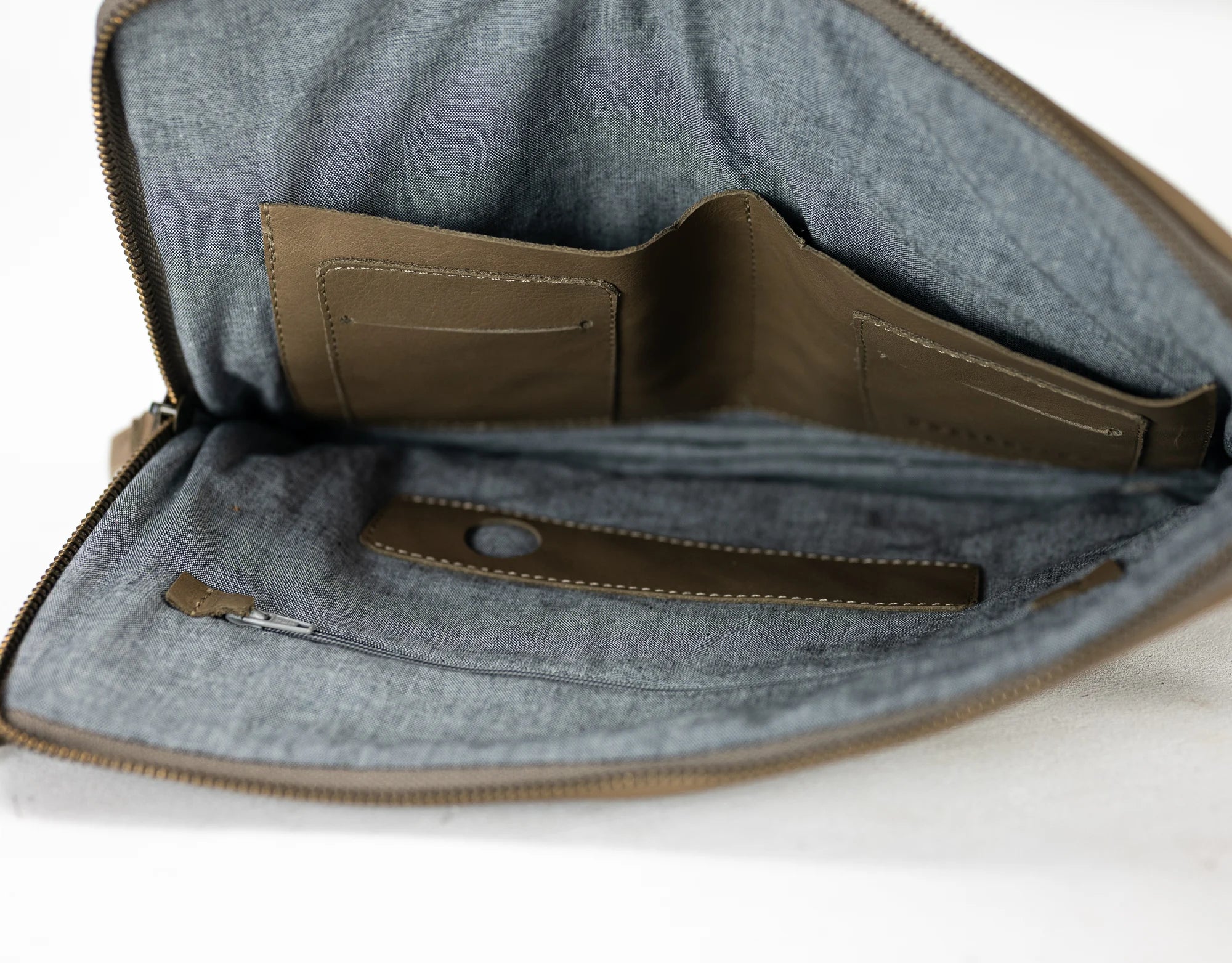 Gray fabric bag with a brown interior pocket on a white background