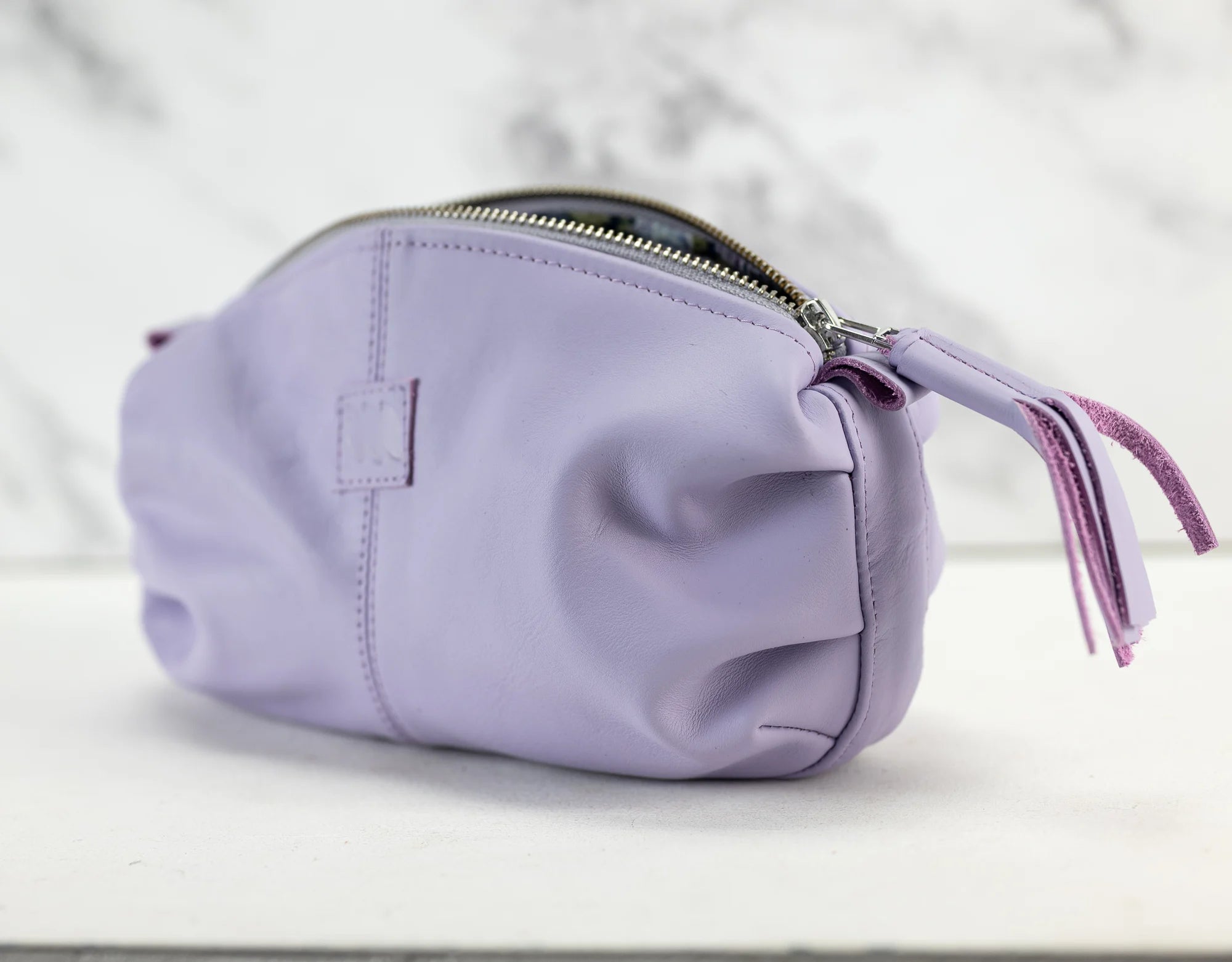 Purple pouch with a tassel on a white background