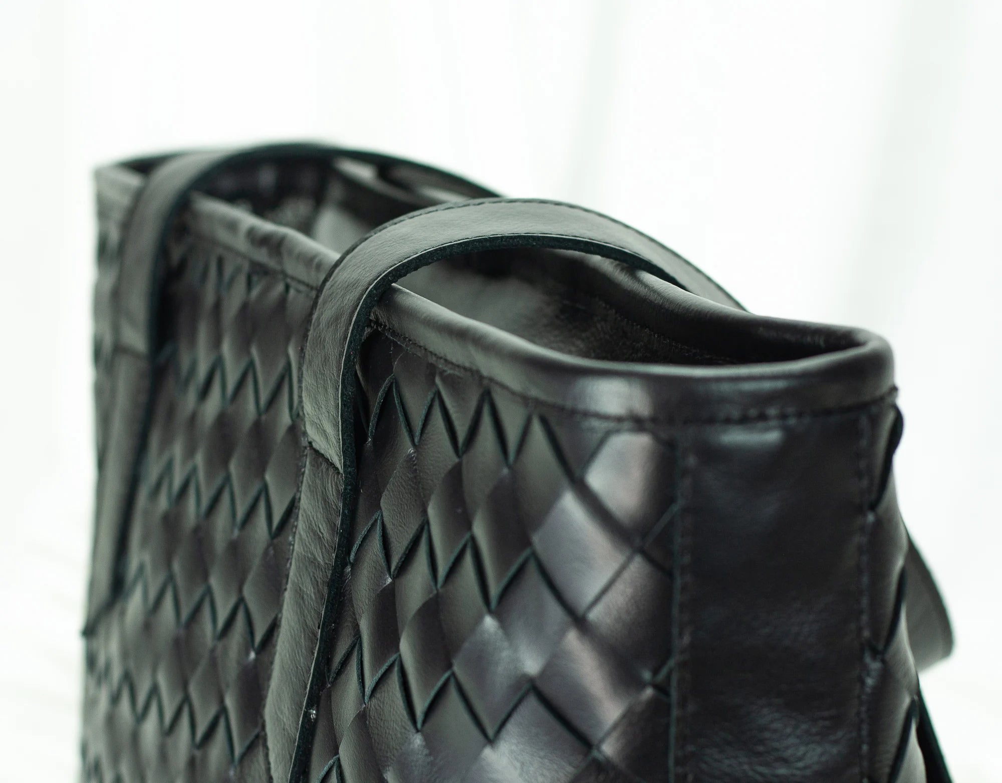 Black woven leather handbag