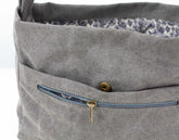 Gray fabric bag insert with a zipper pocket and floral lining on a white background