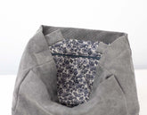 Gray fabric with a floral patterned pocket on a white background