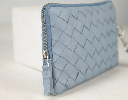 Blue woven clutch bag on a light background