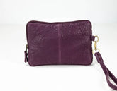 Purple leather clutch bag with a strap on a white background