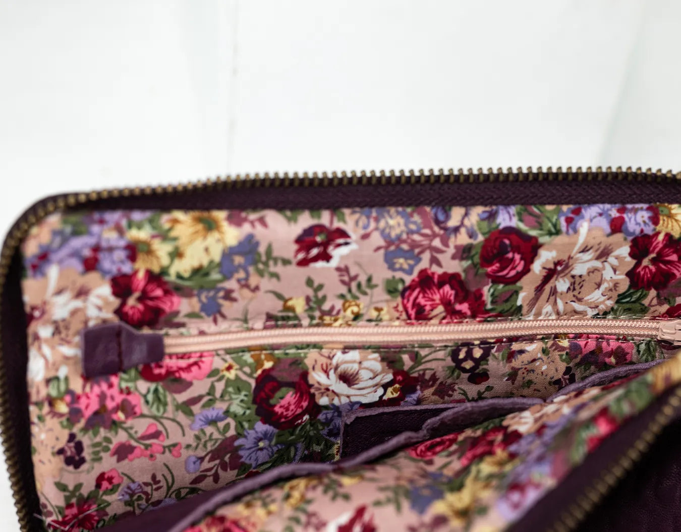 Floral patterned pouch with a zipper on a white background