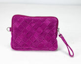 Purple woven clutch bag with a wrist strap on a white background