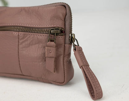 old rose leather clutch with a strap on a white background