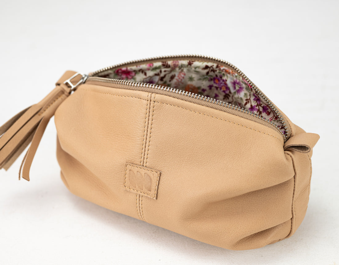 Beige pouch with floral interior on a white background