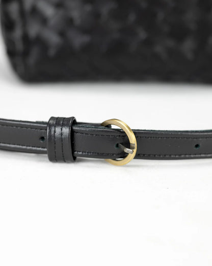 Black woven leather belt with a gold buckle on a white background