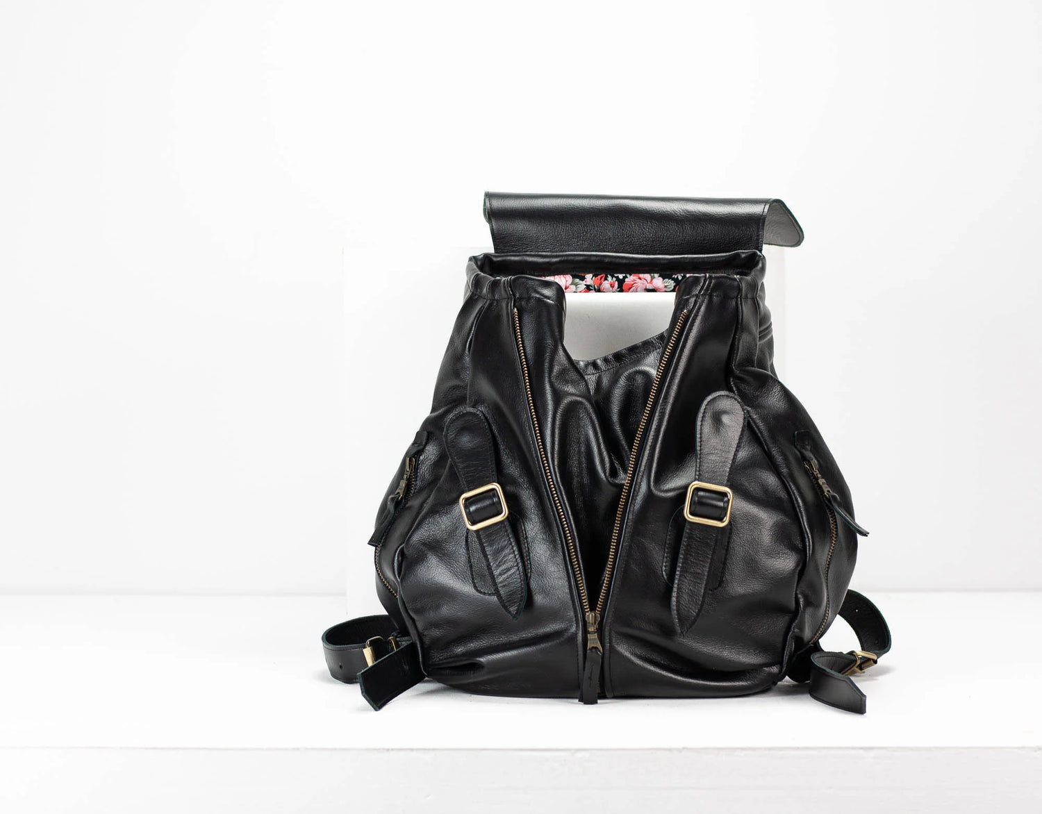 Black leather backpack on a white background