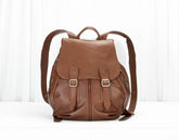 Brown leather backpack on a white background