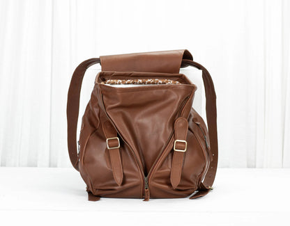 Brown leather backpack on a white background