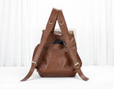 Brown leather backpack on a white background