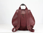 Maroon leather backpack on a white background