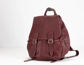 Maroon leather backpack on a white background