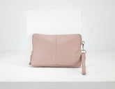 Pink leather clutch bag on a white background