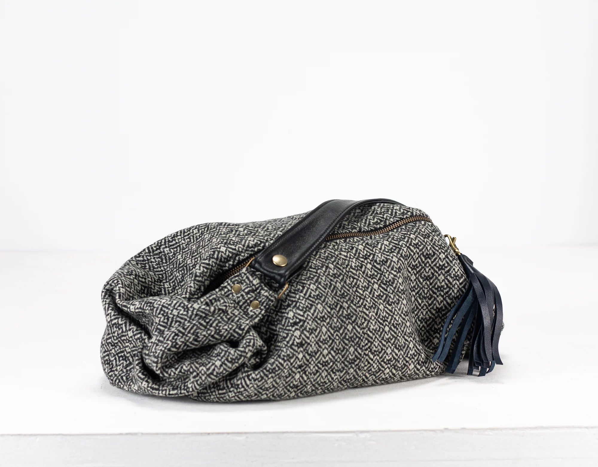 Gray textured bag with black accents on a white background