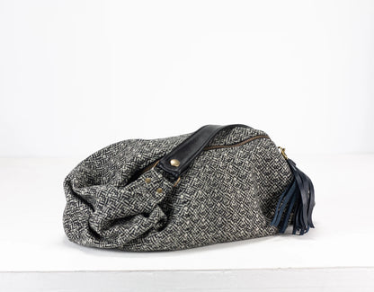 Gray textured bag with black accents on a white background