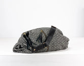 Gray woven bag with black strap on a white background