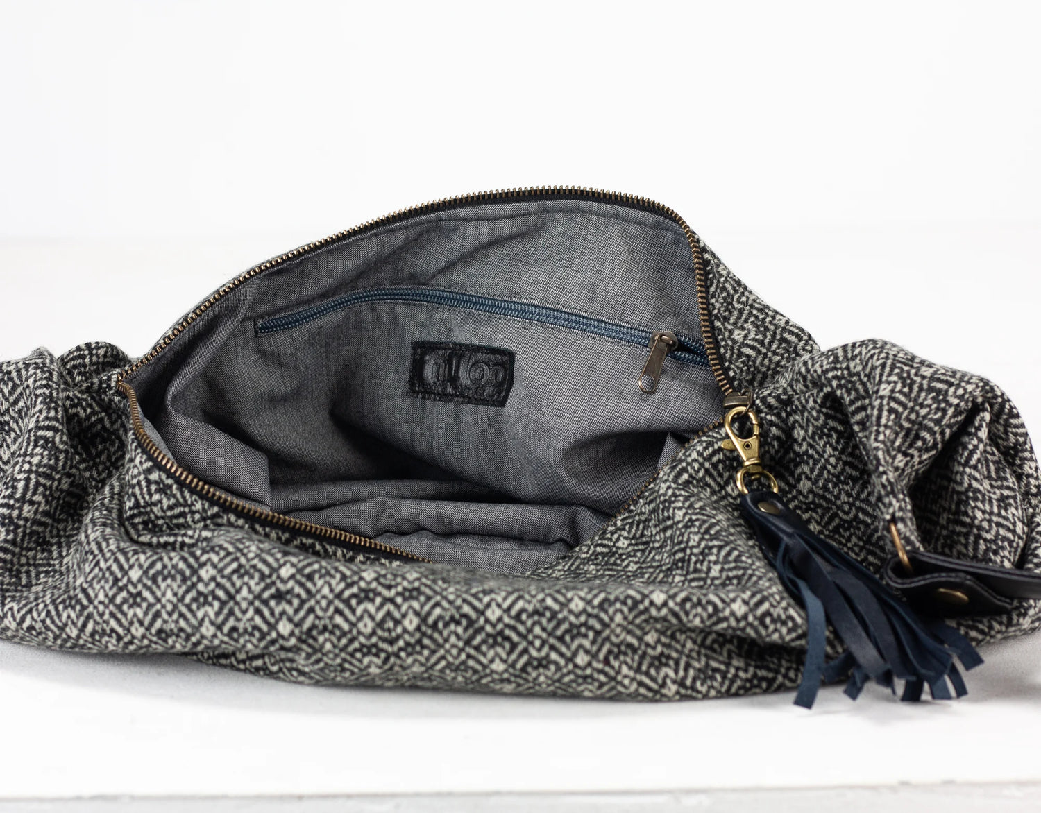 Gray woven bag with a zipper on a white background