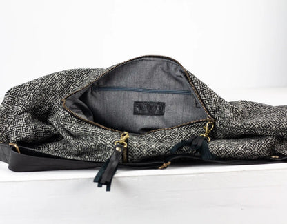 Gray patterned bag with a visible brand logo on a white background