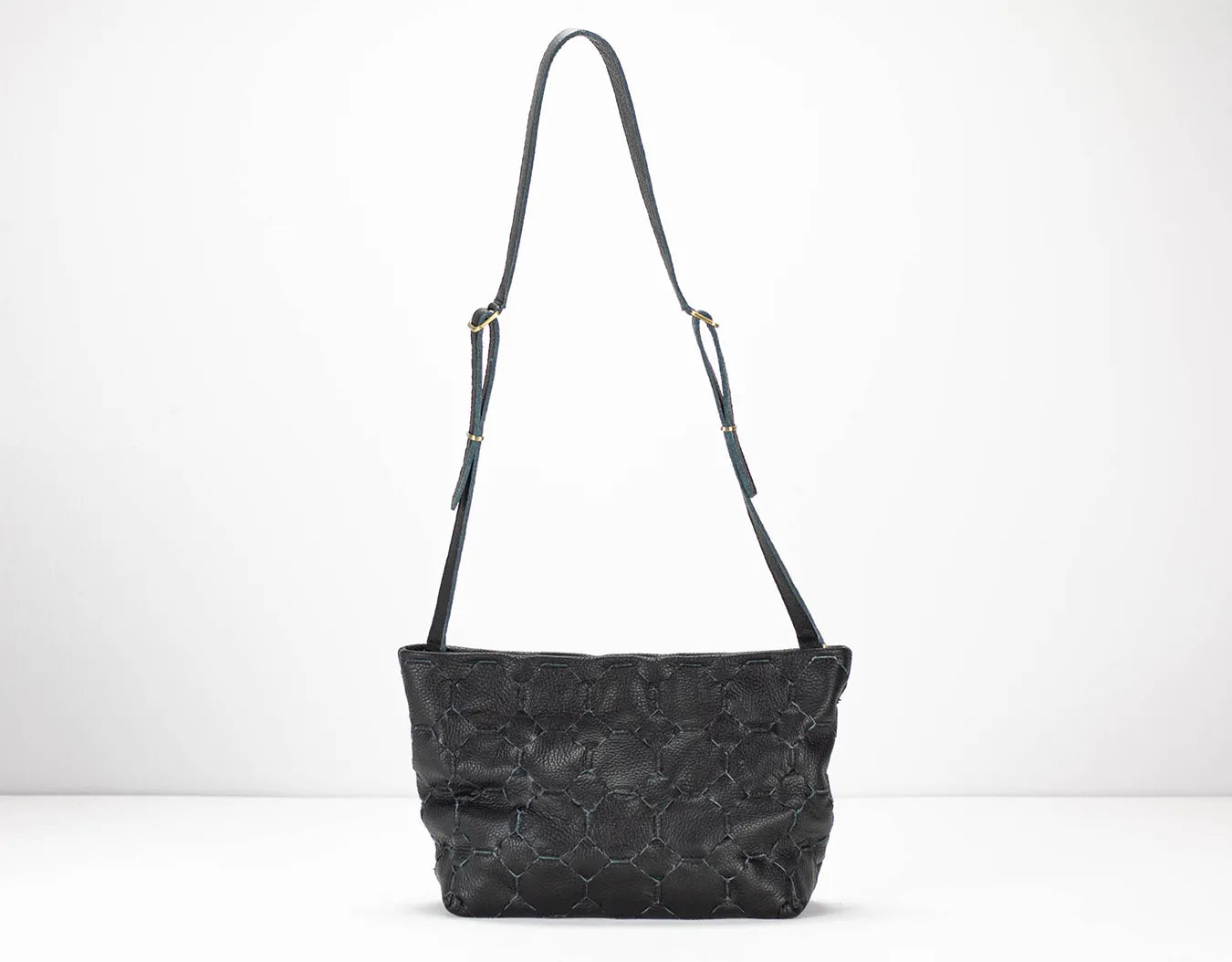 Black textured handbag with a strap on a white background