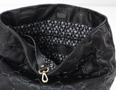Close-up of a black textured handbag with visible brand name.