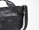 Black textured handbag with a strap on a white background