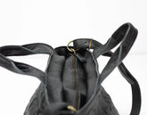 Black leather backpack with a gold zipper on a white background