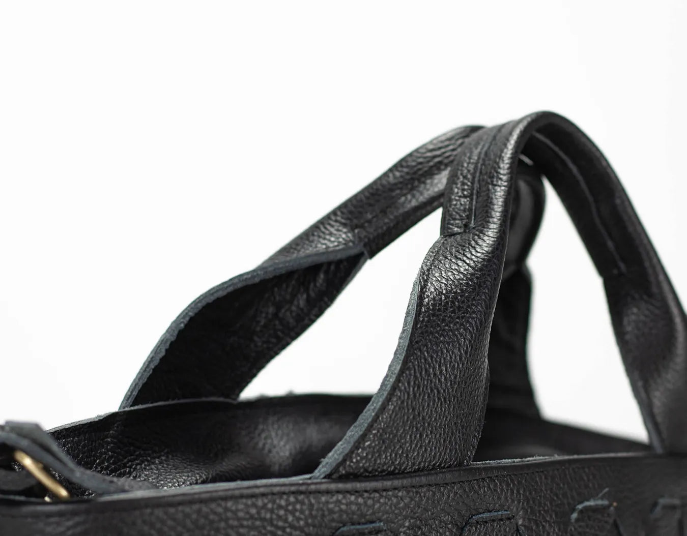 Close-up of a black bag with a strap on a white background