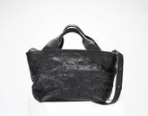 Black textured handbag on a white background
