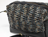 Black and gold patterned handbag on a white background