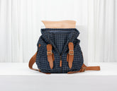 Blue patterned backpack with brown straps on a white background