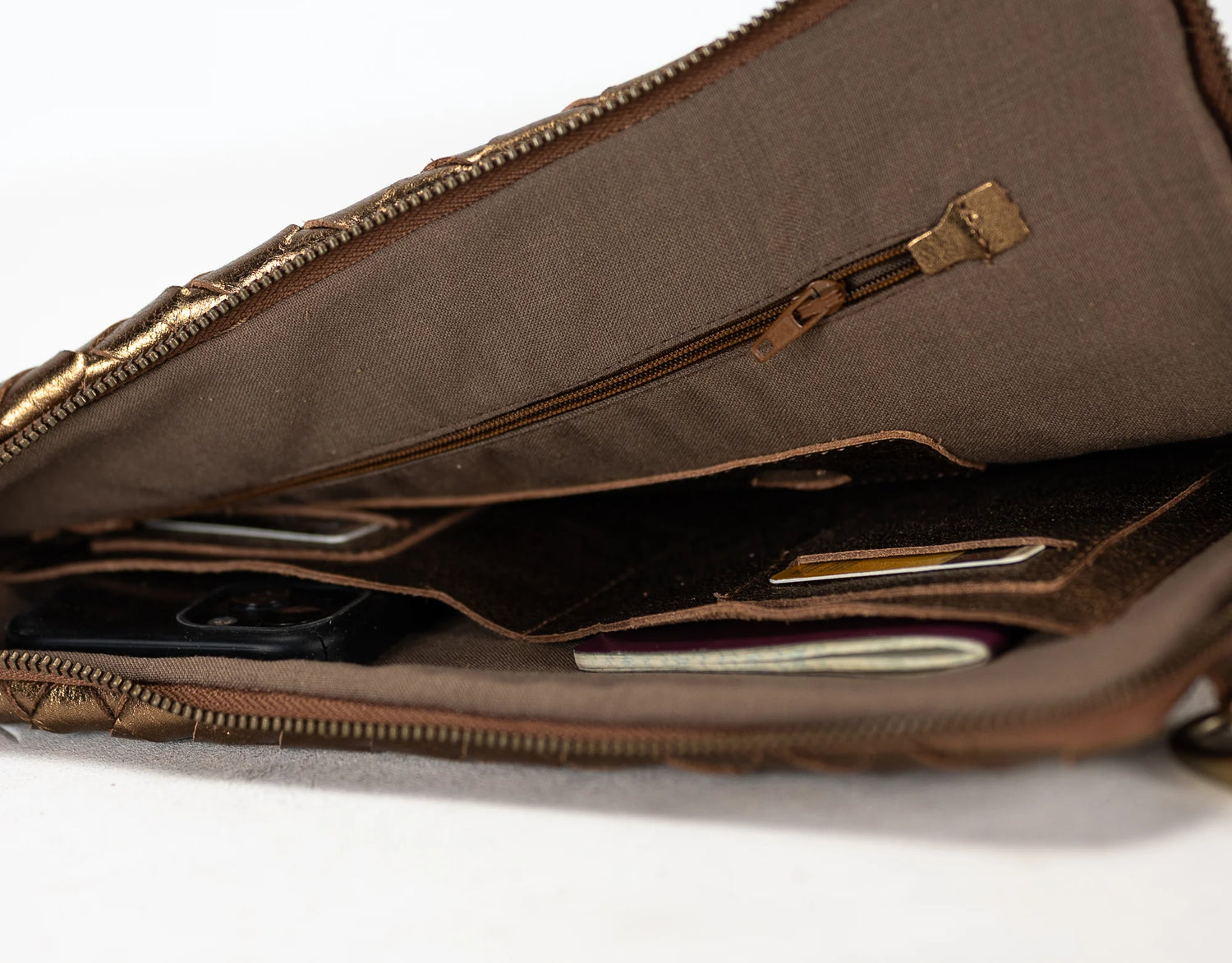 Brown leather bag with a zipper on a white background